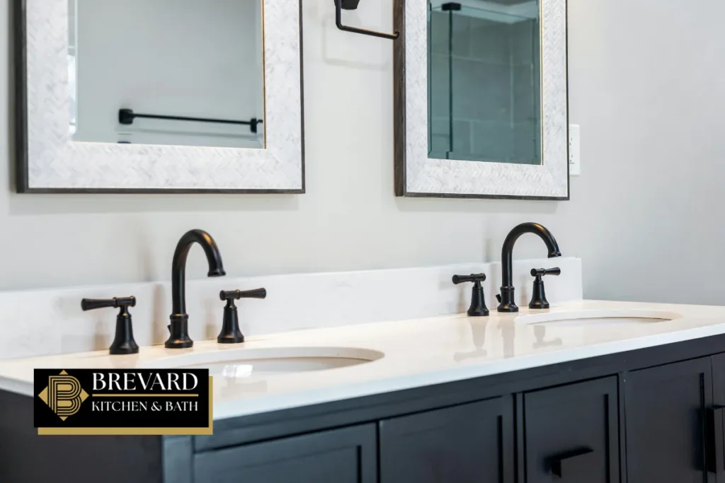 Two sinks with black faucets on a navy double vanity
