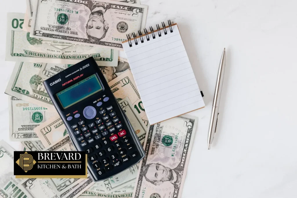Calculator and cash for estimating tub-to-shower conversion costs