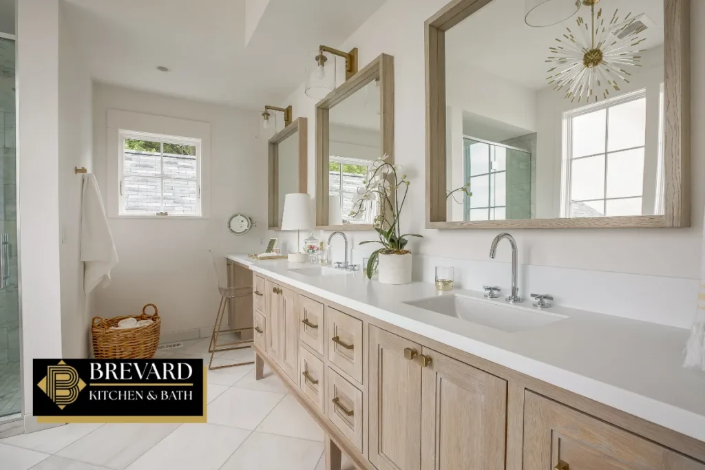 Long double vanity with light wood cabinets in a remodeled bathroom