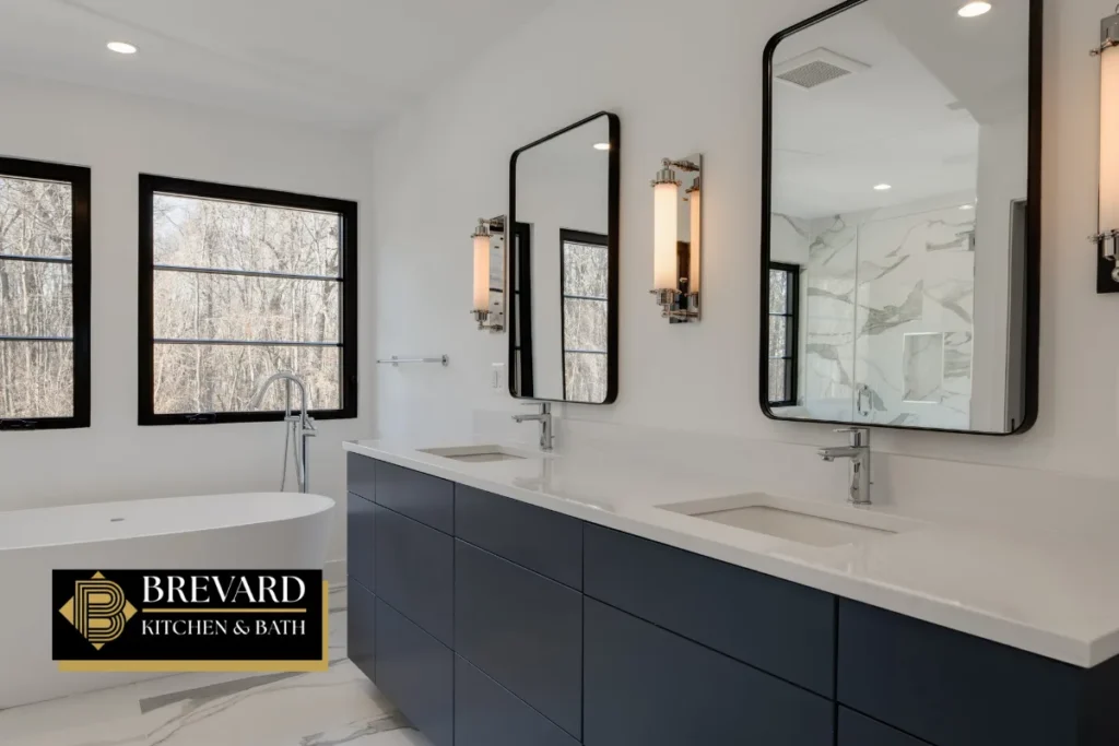 Navy double vanity with black-framed mirrors and wall sconces