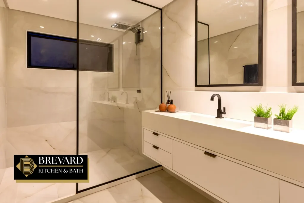 Floating white double vanity next to a glass walk-in shower