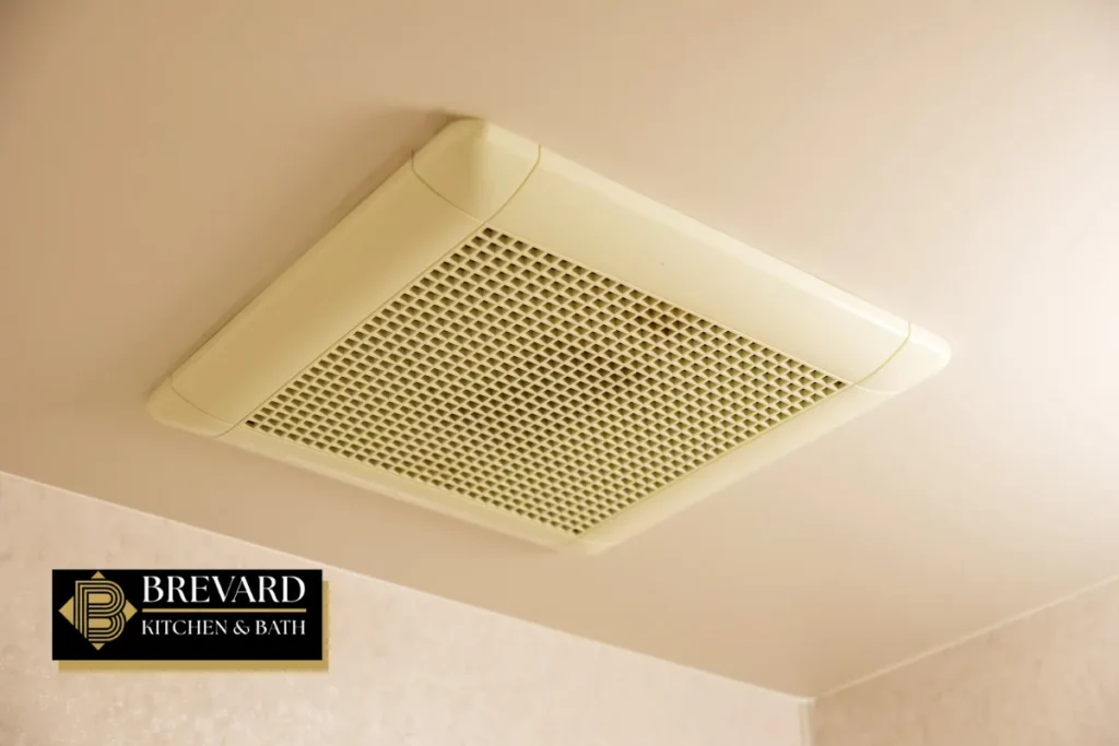 Ceiling bathroom exhaust fan with a vent grille