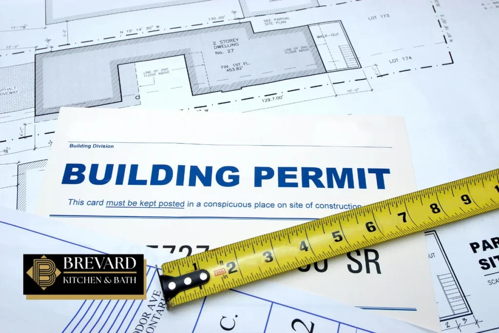 Building permit document and tape measure for a bathroom remodel