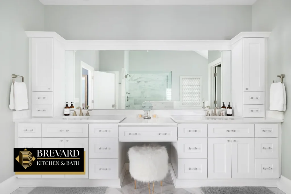 Wide white double vanity with a center makeup station