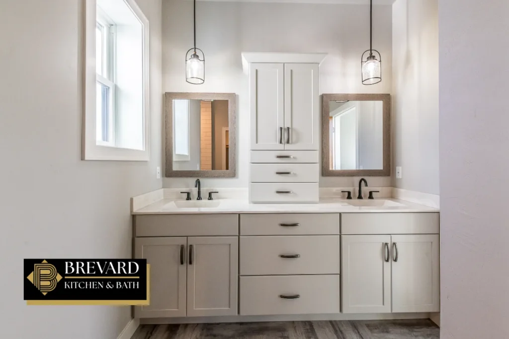 Gray double vanity with two mirrors and a linen tower